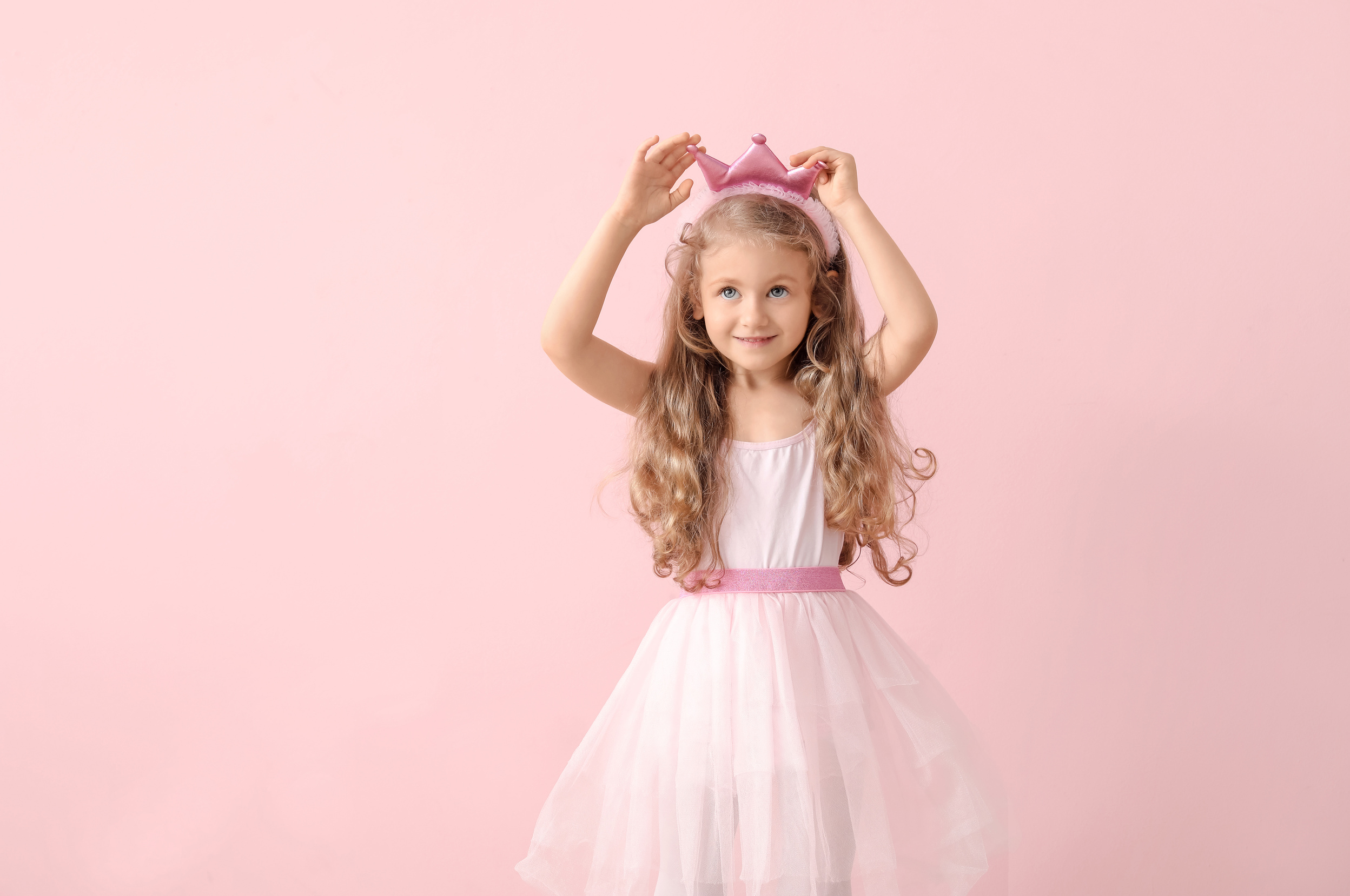 Girl Wearing Princess Costume on Pink Background